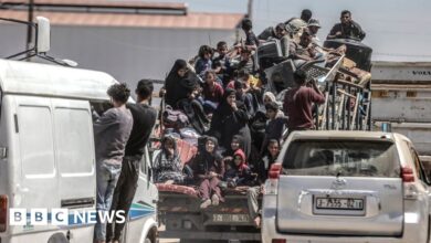 Palestinians cram on to a van after deciding to flee Rafah, as Israeli forces continue a ground operation in the southern Gaza city (8 May 2024)