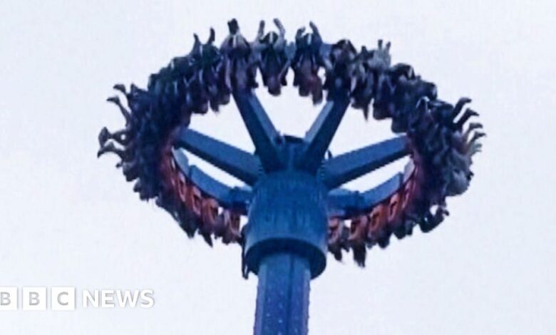 People hang upside down while on amusement park rides