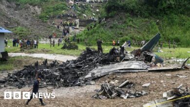 Watch: Rescue workers search through the wreckage of a plane crash in Nepal