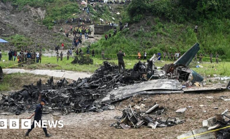 Watch: Rescue workers search through the wreckage of a plane crash in Nepal