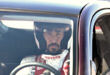 Keanu Reeves speeds around the Indy 500 racetrack