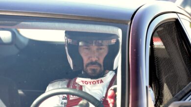 Keanu Reeves speeds around the Indy 500 racetrack