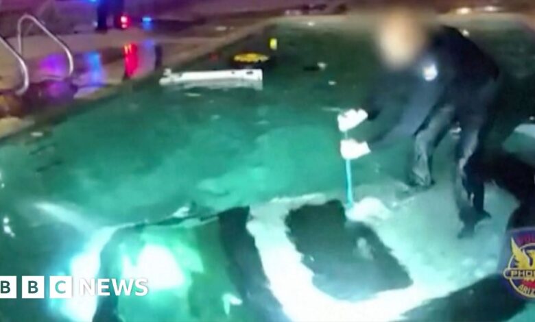 The moment police rescued a man trapped in a flooded car