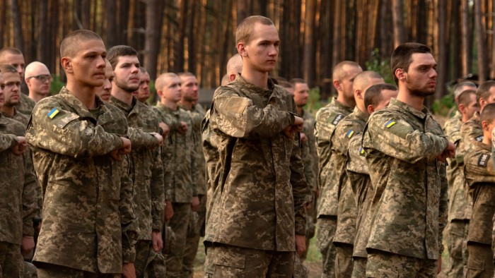 Newly recruited soldiers of Ukraine’s 3rd Assault Brigade line up at a military base close to Kyiv