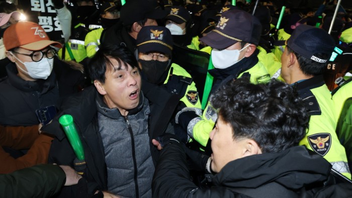 Protesters in Seoul clash with police officers outside the National Assembly