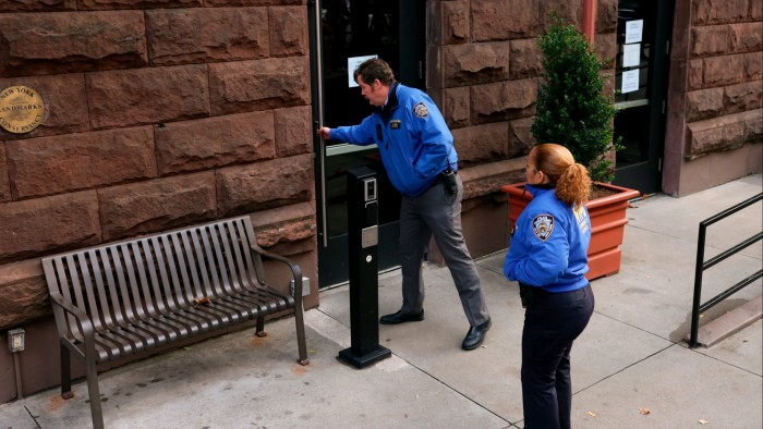 New York Police community affairs officers enter the HI New York City Hostel on December 5 2024 where police say the suspect in the killing of UnitedHealthcare chief executive Brian Thompson may have stayed